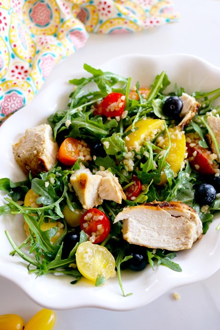 Packed with juicy fruits, peppery arugula and grilled chicken, this summery salad will quickly become a mainstay in your recipe repertoire this season.