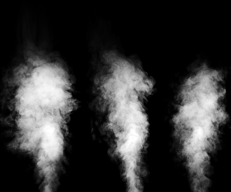 three blasts of white steam shoot upward in front of a black background