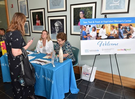 Volunteers with the Kapiolani Women's Center answer a patient's questions during a free cancer screening and health fair for uninsured and underinsured women put on in part by the national See, Test & Treat program in June 2019.
