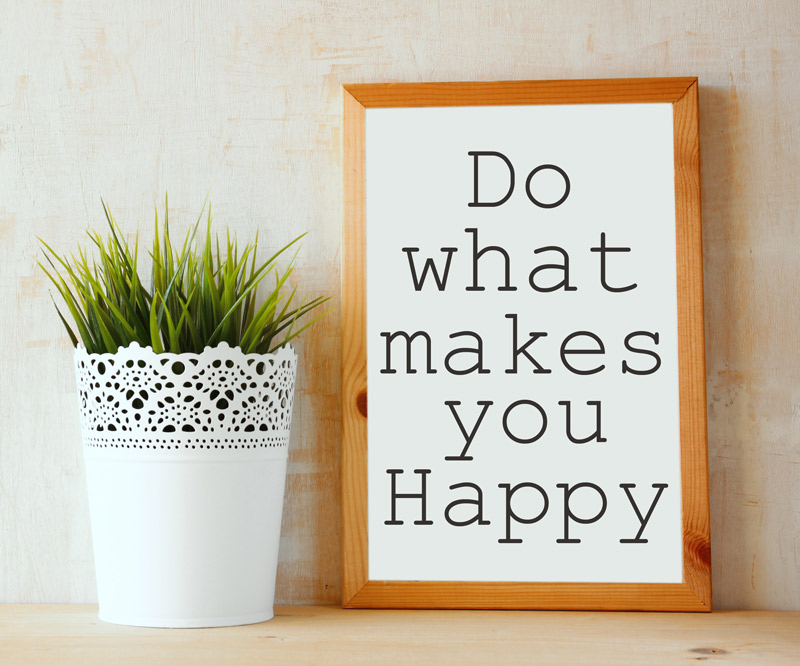 a framed sign that says "Do What Makes You Happy" on a wooden counter top next to a potted succulent
