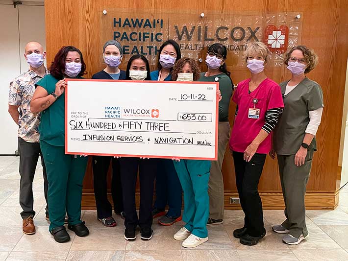 group shot at Wilcox Medical Center with giant check