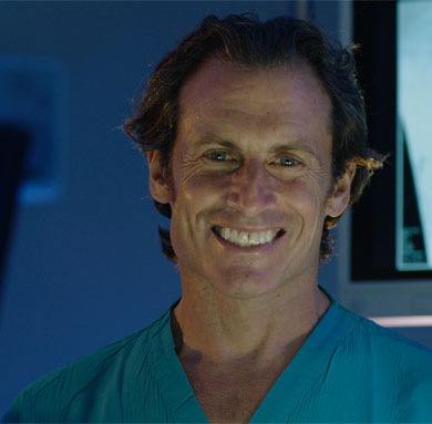 Smiling doctor in scrubs.