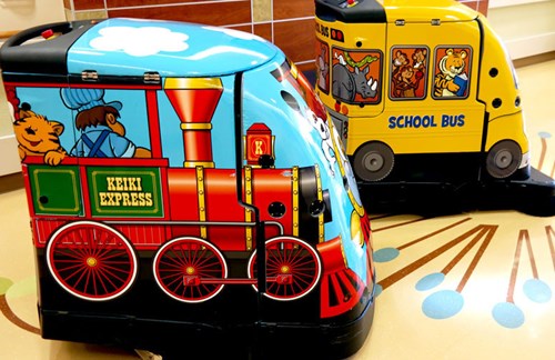 A side view of the bots as their alter egos: the Keiki Express and the Kapiolani School Bus.