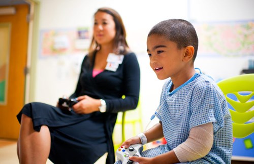 Child and therapist playing video games