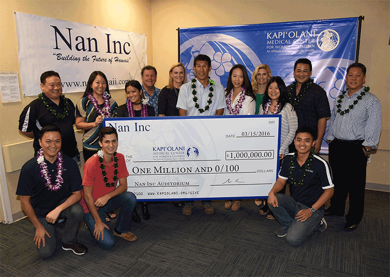 Group taking photo holding cheque from Nan Inc