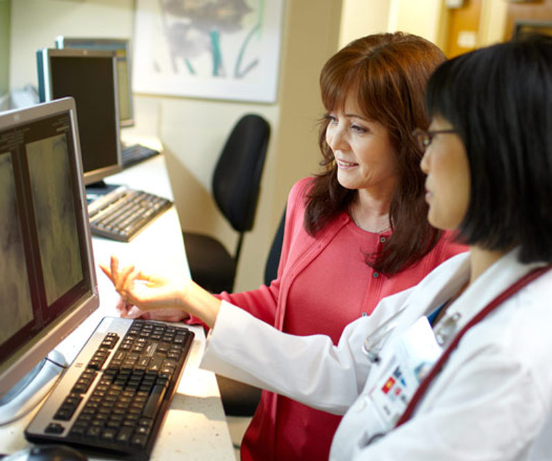 Doctor examining a scan with her patient