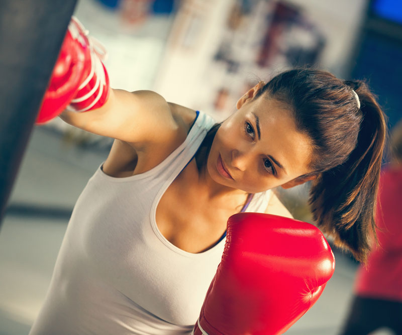 a female boxer punching a bag