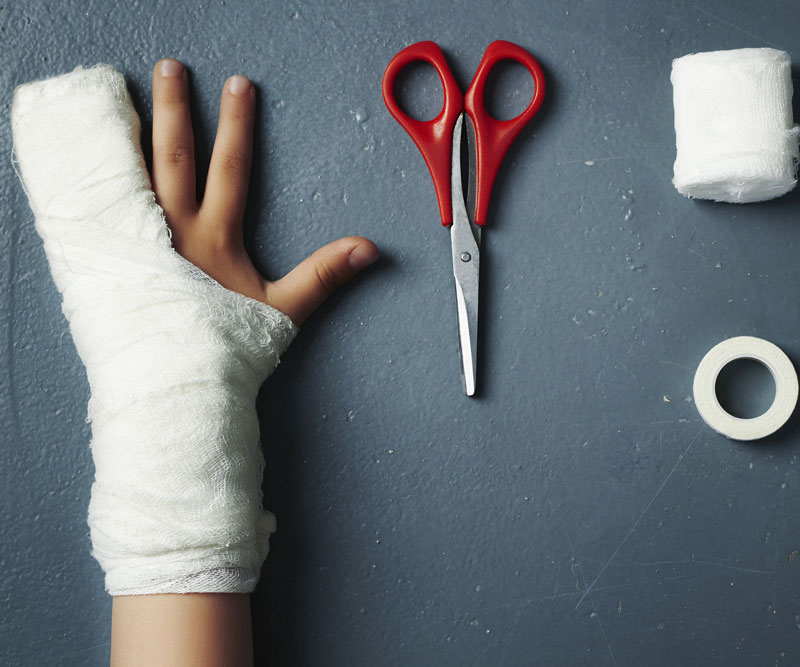 an illustrated injured child hand reaching scissor