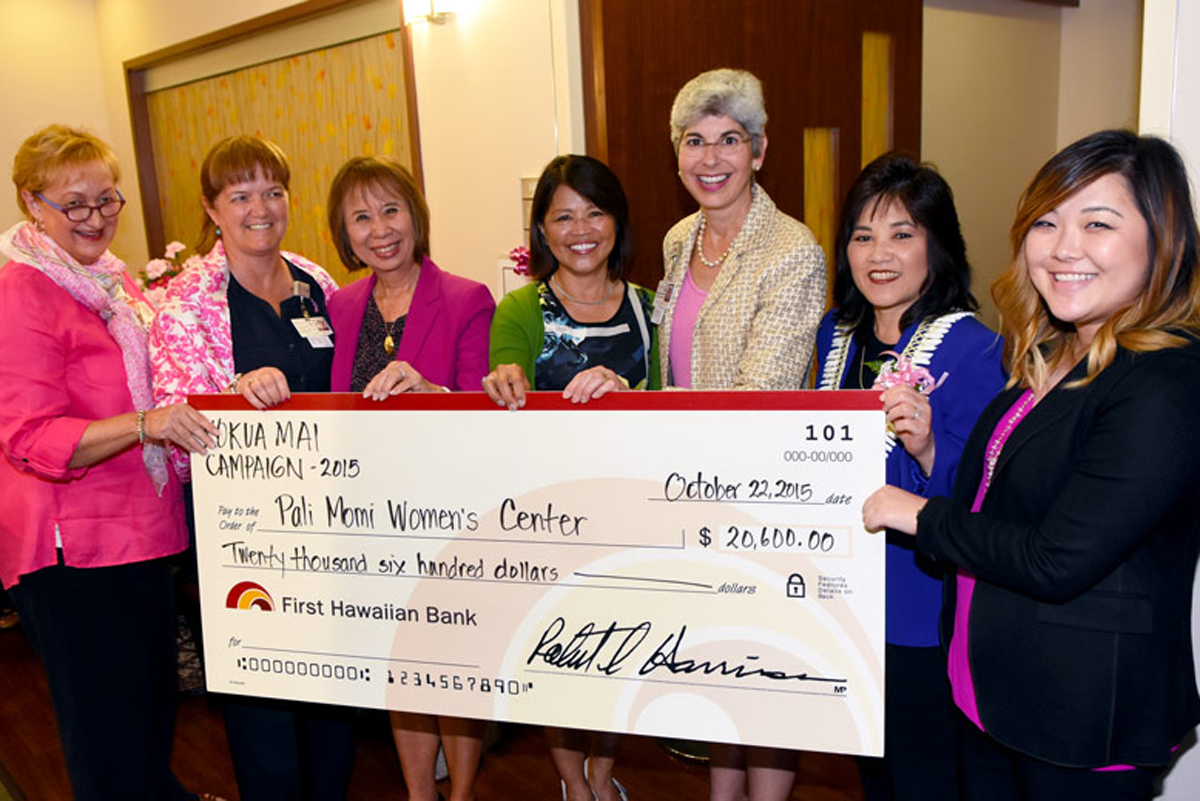 Pali Momi leadership and Women's Center staff holding a check donation from First Hawaiian Bank