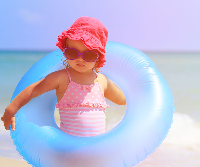 a child holding a flotation device