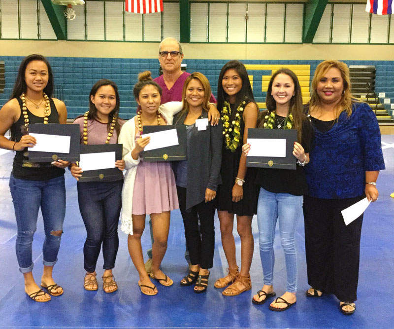 group of high school students with scholarships in hand