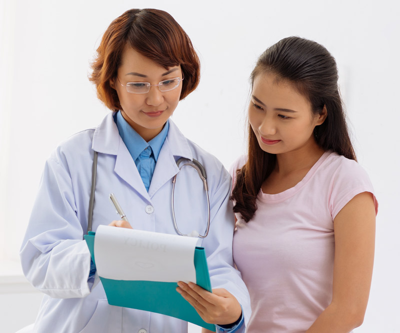 doctor examining a report with her patient