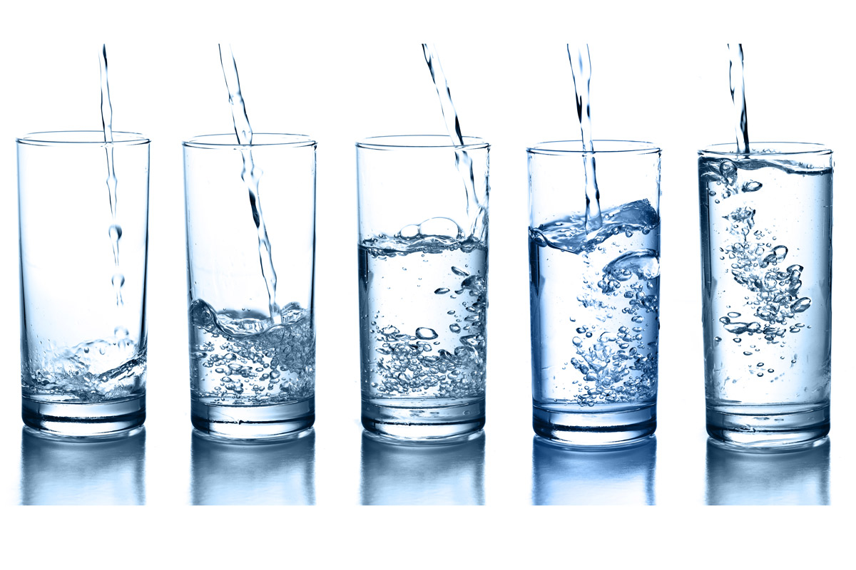 five glasses of water at varying levels