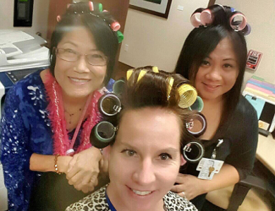 Three women wearing hair rollers