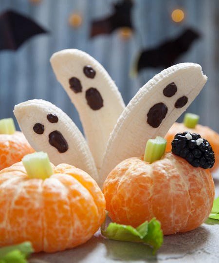  Banana Ghosts and Pumpkin Tangerines carved and prepared for Halloween party.