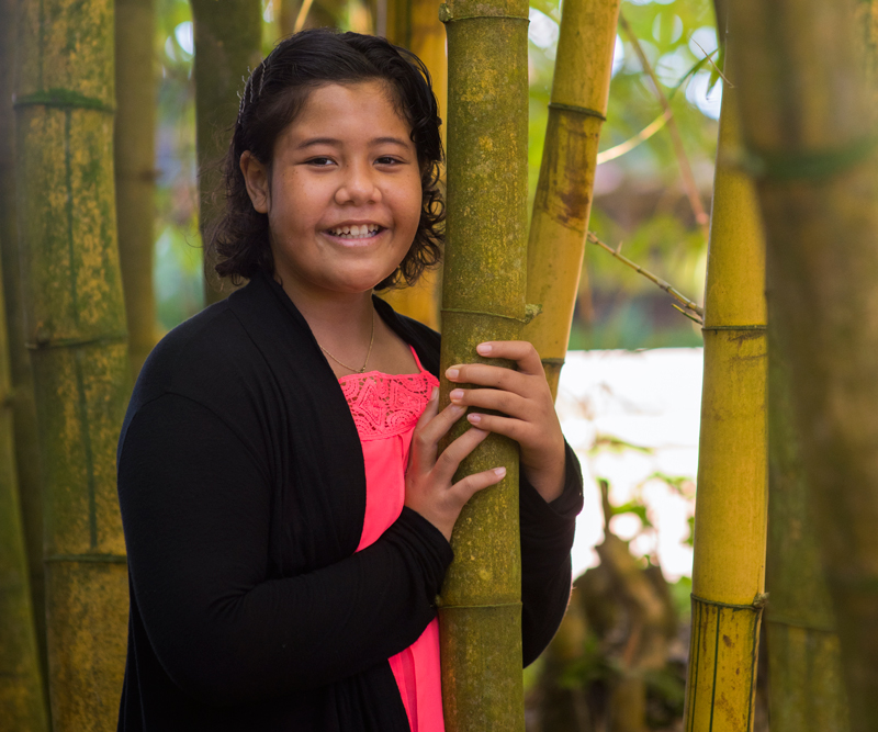 Rachel Ashley Ioane holding on bamboo tree