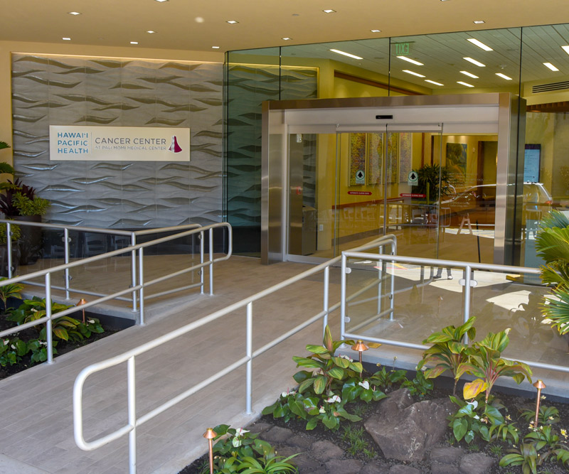 The entry to the Hawaii Pacific Health Cancer Center at Pali Momi Medical Center was designed with patients in mind, from its beautifully landscaped walkway to to large glass doors to let in natural light wheelchair ramp for easy accessibility.