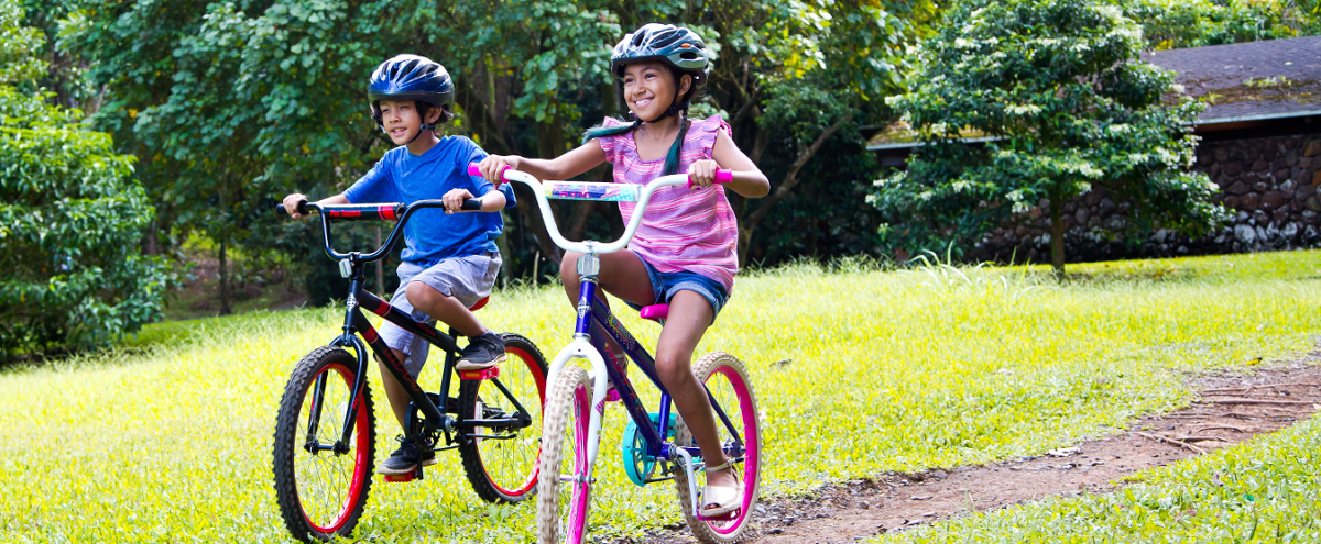 two children riding their bicycles together