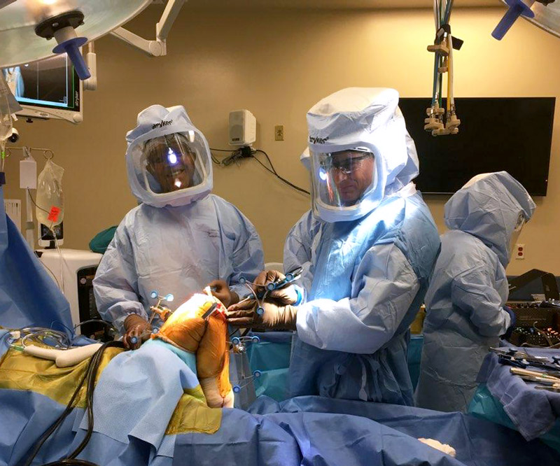 Dr. David Rovinksy and Dr. Erik Zeegen perform robotic-assisted total knee replacement surgery on cadavers.