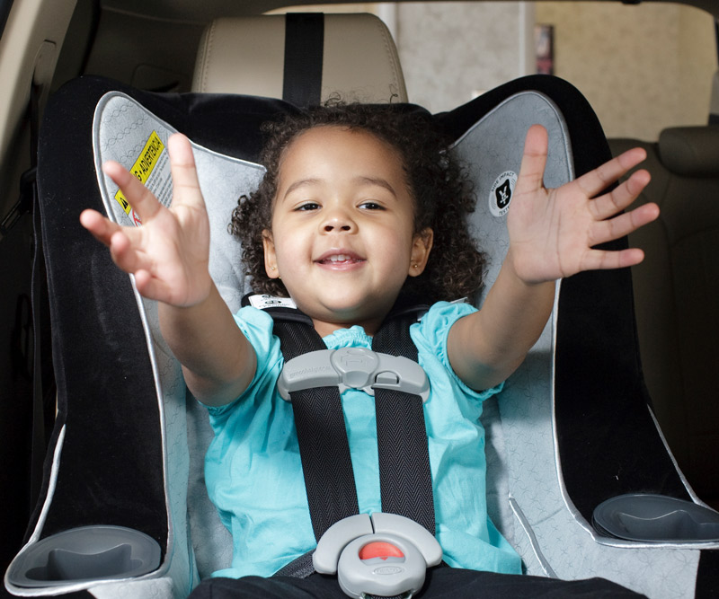 Child sitting in a forward-facing car safety seat