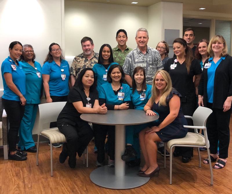 Hawaii News Now "Sunrise on the Road" reporters Dan Cooke, Steve Uyehara and Howard Dicus pose for a group shot with staff members from the Pali Momi Infusion Center
