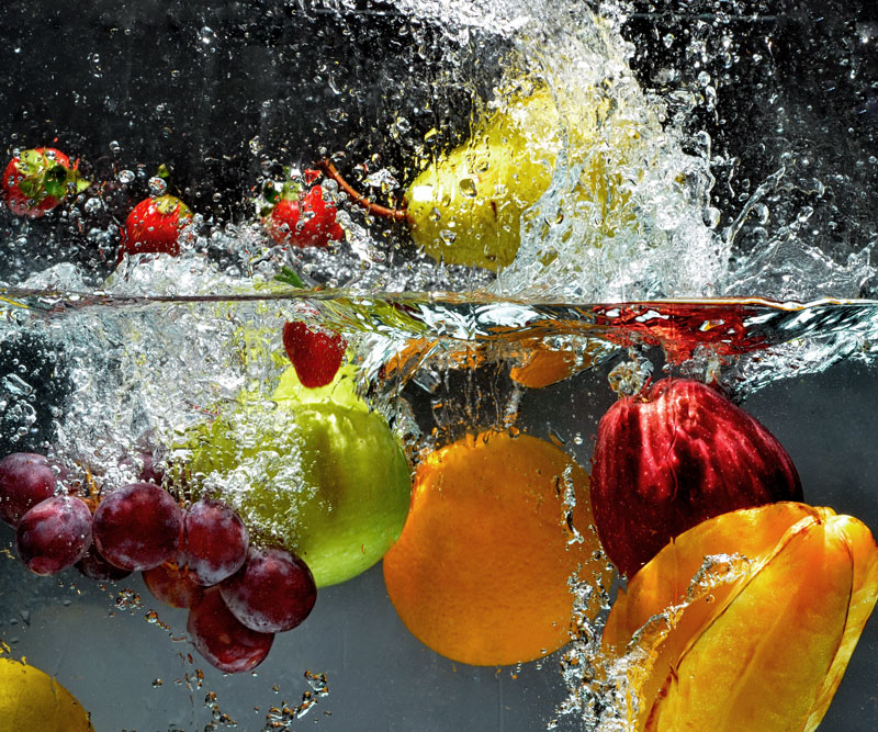 fruit being dropped into water
