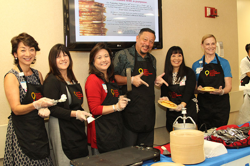 Photo includes (l to r) Dawn Ching, Laura Bonilla, Carrie Ann Tsutsui, Joel Emperador, Mavis Nikaido and CEO Martha Smith, flipped and served more than 500 pancakes for medical center employees and visitors.