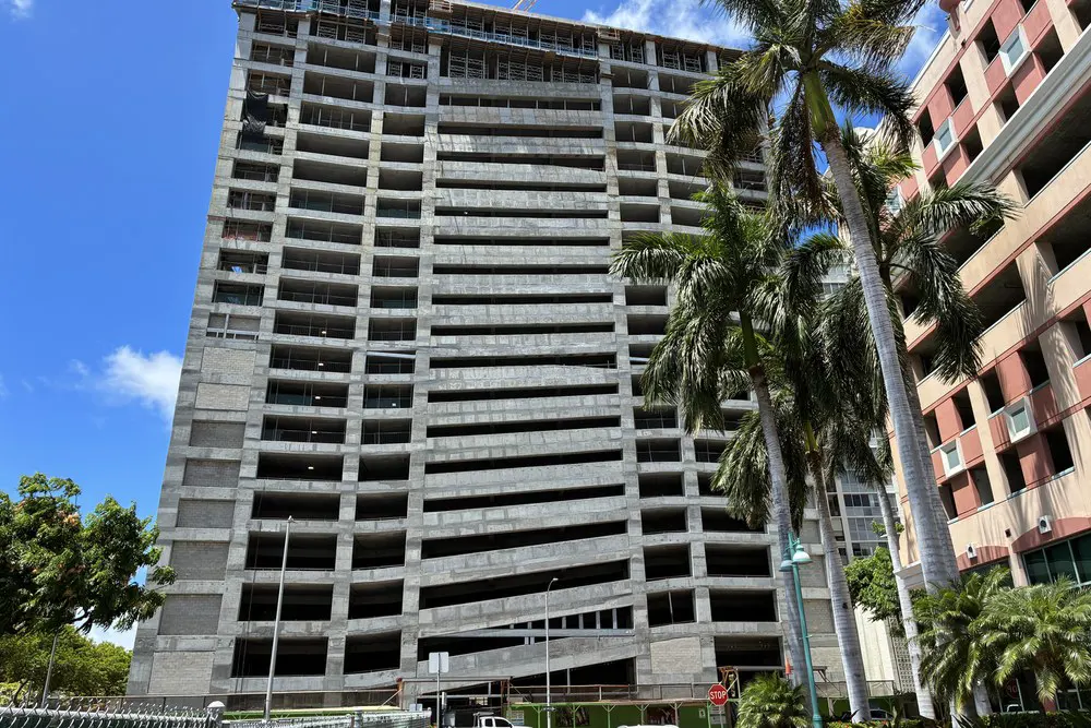 Street-level view of the parking building beside a neighboring structure.