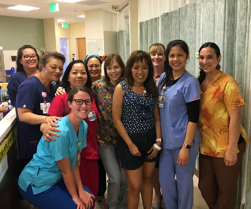 Cheri Beddow poses for a group photo with nurses in the Pali Momi Infusion Center