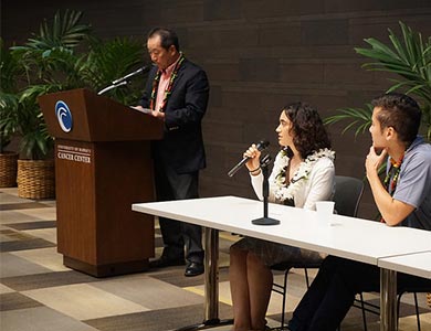 Dr. Charles Kim standing behind the podium during a Q&A session at the UH Cancer Center Prostate Cancer Symposium