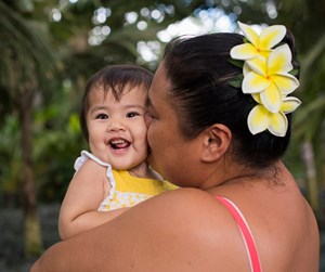 Grace Sakamoto gets a big kiss from her mom, Lei Ann