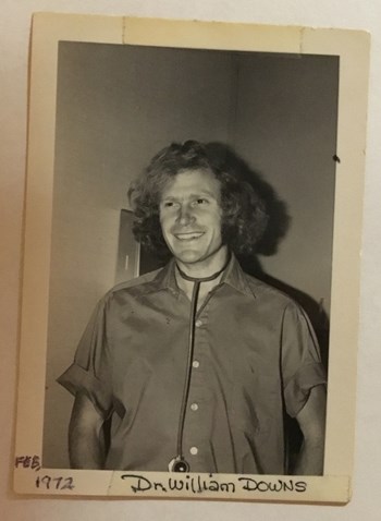 A black-and-white photo from February 1972 shows a 26-year-old Dr. Monty Downs on his first day on the job at Wilcox.