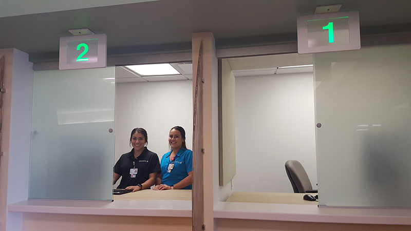 Two women standing at clinic check-in counter