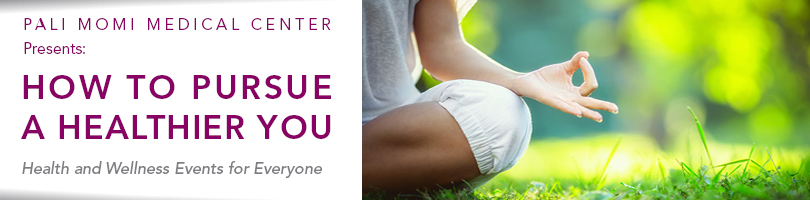 women sitting on the grass doing yoga