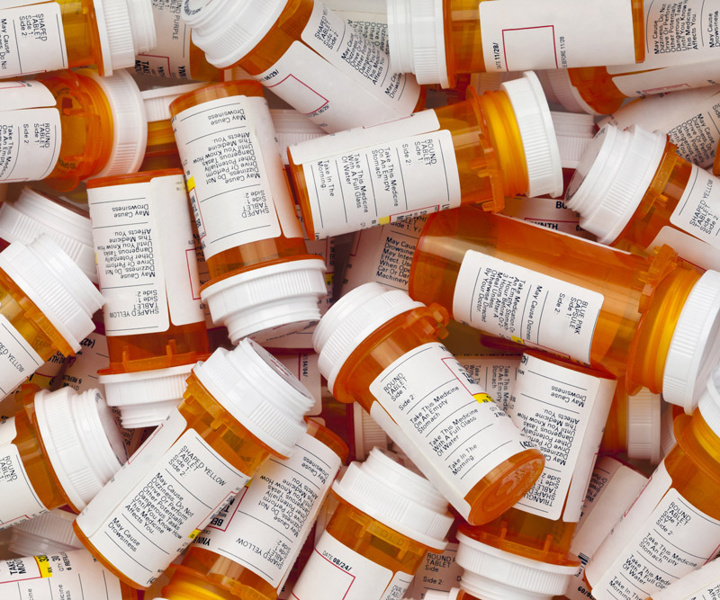 A pile of prescription medication bottles