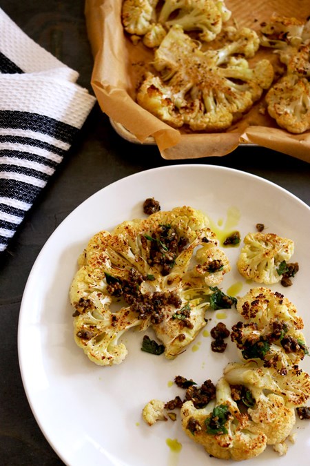 Roasting cauliflower produces a sweet, tender steak that pairs perfectly with a savory sauce. Fell free to play with other flavor combos like curry and chutney, pesto and rosemary, or a simple blend of fresh herbs with a squeeze of fresh lemon and capers.