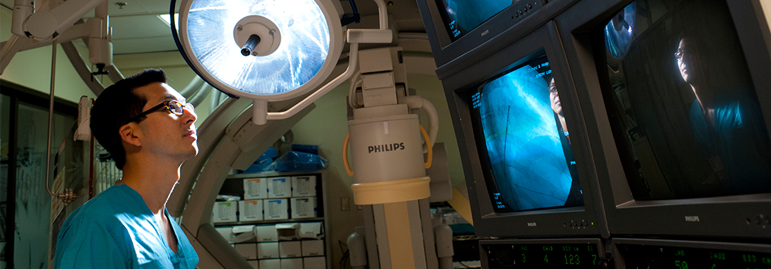 Provider looking at a monitor with an image of a heart on it.