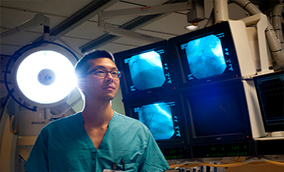 Doctor standing next to monitors in the Laboratory.