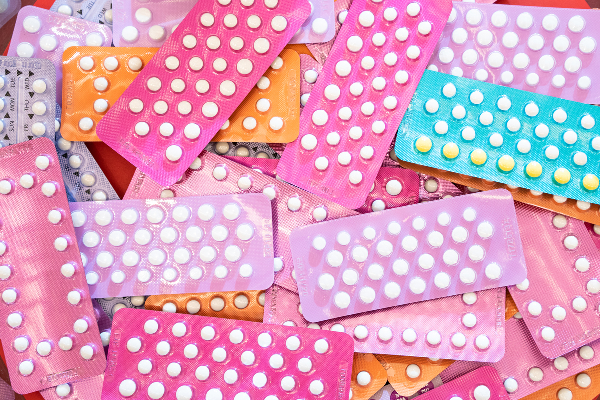 brightly colored packs of The Pill birth control method piled on top of each other