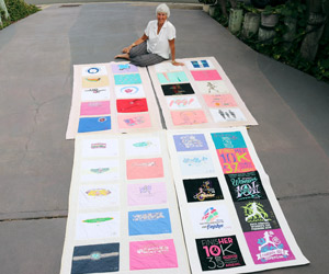 Gerry DeBenedetti sits in her driveway surrounded by her four quilts