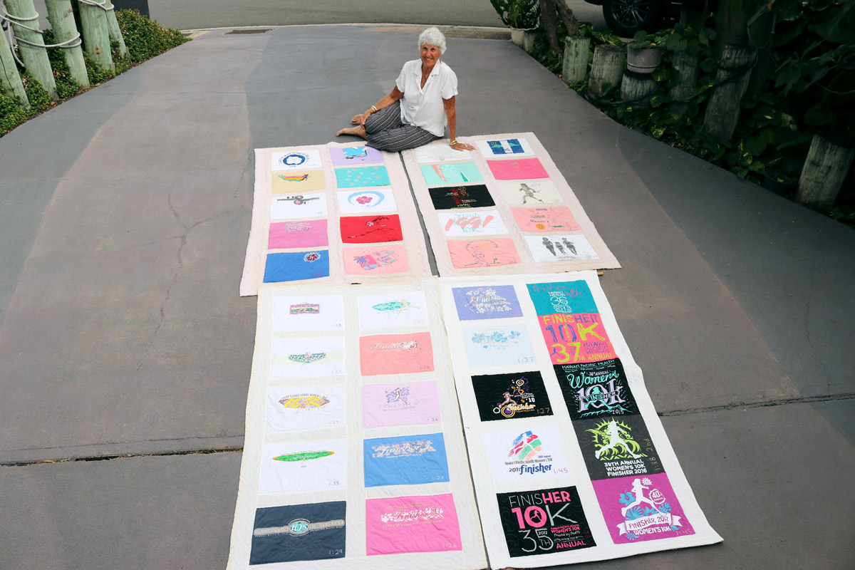 Gerry DeBenedetti sits in her driveway surrounded by her four quilts