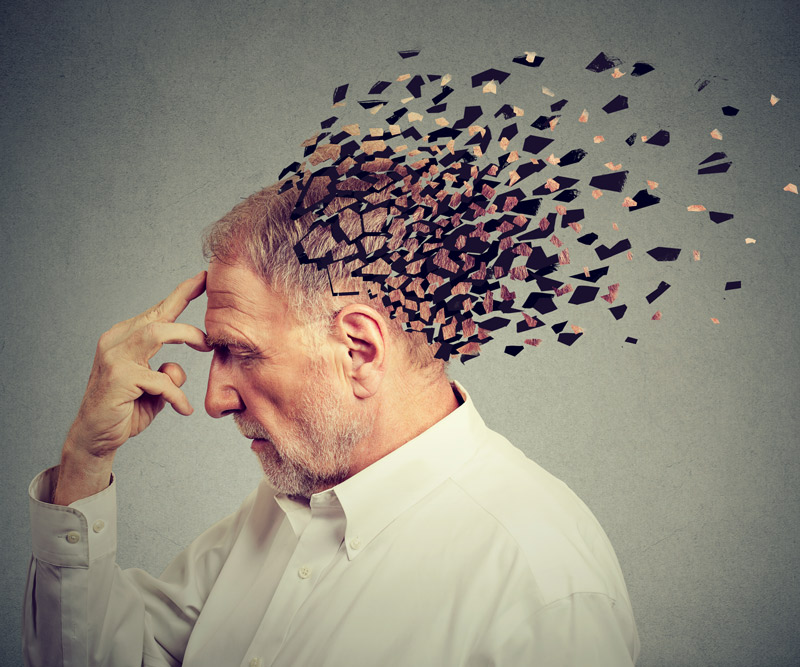 depiction of a man with pieces of his head fading away to represent memory loss