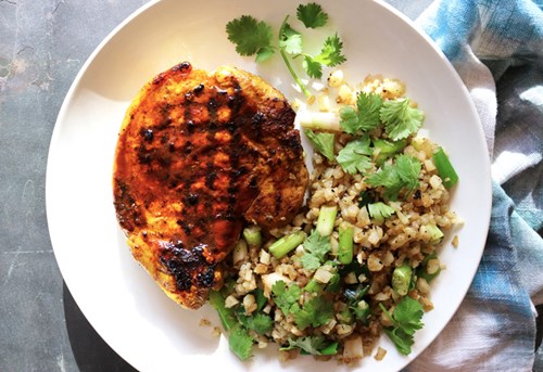 Turmeric – a bright-yellow spice lauded for its anti-inflammatory properties – gives pork chops a deep-golden hue reminiscent of a summer sunset. Serve alongside cauliflower rice dotted with colorful green onions and cilantro for a dreamy dish.
