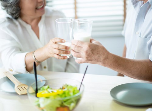 Toast to healthy bones by consuming calcium-rich foods like milk and green leafy vegetables.