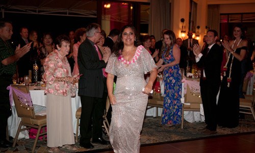 Pink Tie Ball honoree Dr. Laura Peterson makes her way to the podium during the ceremony for Susan G. Komen Hawaii's 8th annual Pink Tie Ball.