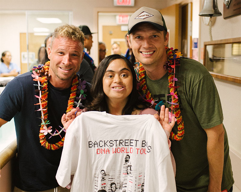 Backstreet Boys members Brian Littrell and Nick Carter with female cancer patient