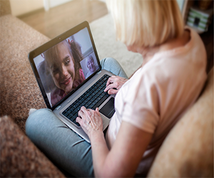 Woman video chatting on laptop