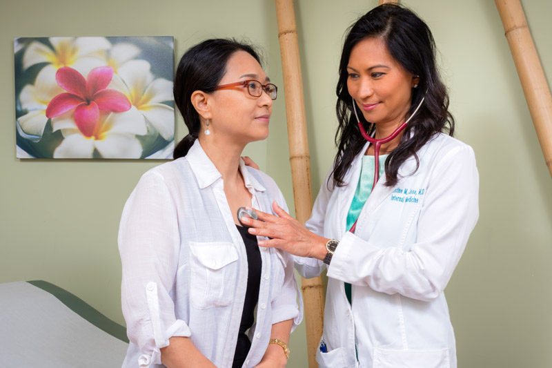 Female Doctor checking a patient.