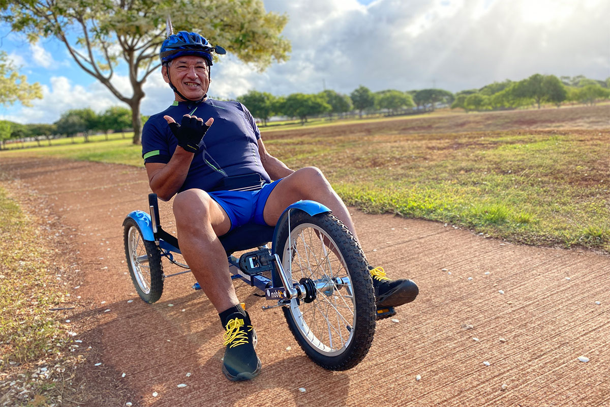 Jesse (Jesus) Ponce on a three-wheeled bicycle in the park