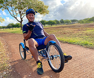 Jesse (Jesus) Ponce on a three-wheeled bicycle in the park